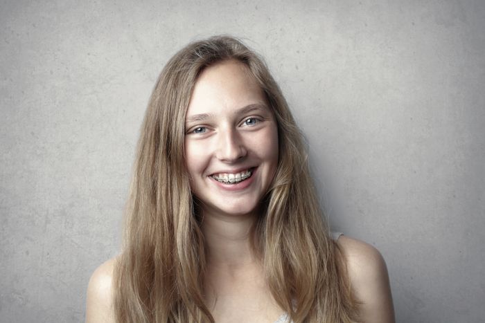 Jeune patiente souriante portant des bagues dentaires